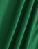 A close-up of green fabric with a textured surface, suitable for polo shirts. It features folds and a smooth appearance.