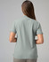 A ladies cotton stretch polo shirt in a muted green colour, featuring a collar and short sleeves.