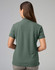 A ladies cotton stretch polo in a muted green colour, featuring a simple design with a logo on the back.