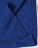A navy blue polo shirt with a textured fabric and folded hem detail. Features branding on the label.