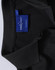 A black polo shirt with a collar and a tag featuring a logo.