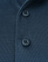Close-up of a navy blue poly/cotton polo shirt featuring two buttons and a textured fabric. Includes a logo.