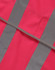 A pink safety vest featuring grey reflective shoulder tapes, designed for visibility and safety.