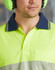 A close-up of a unisex, long-sleeve, high-visibility polo shirt in vibrant yellow with a navy collar and a pocket.
