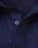 A navy blue long sleeve work shirt with a closed front and mesh interior. It features a button at the collar and has a branded logo.