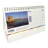 A wiro-bound tent desk calendar featuring a scenic image and a calendar grid, predominantly in white with colourful accents.