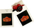 A branded flip lid cardboard box containing red and black choc beans, featuring a logo on the front.