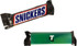 A Snickers chocolate bar wrapped in a black and blue wrapper, featuring a logo and an additional green sleeve.
