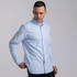 A light blue button-up shirt for men, featuring a collar and a chest pocket, with a logo on the fabric.