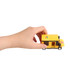 A hand holds a yellow toy delivery truck made of building blocks with a logo on the side.
