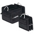 A black organiser with multiple compartments, featuring metallic handles and side pockets for storage.