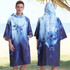 A hooded change towel featuring a blue gradient design with an ocean theme. It has a logo on the front.