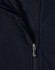 A navy softshell high-tech jacket featuring a zippered front and a fleece lining. The jacket includes a logo.