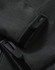 A close-up of grey softshell fabric featuring black fasteners and cuffs on a full zip hoodie. It includes a branding logo.