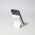 A black and white Turbo 5000mAh wireless charging power bank set on a stand, showcasing its sleek design.