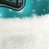 A close-up of a soft, white faux fur trim on a vibrant blue fabric, featuring a pattern.