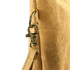 A close-up of a tan kraft paper cosmetic bag with a metal clasp and strap attachment.