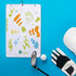 A waffle-pattern golf towel in white with colourful abstract designs, accompanied by a golf club, ball, and glove.