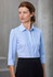A light blue women's button-up shirt with 3/4 sleeves, featuring a collar and a logo.