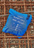 A blue packable rain jacket folded into a compact pouch with a logo and zipper.