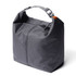 A grey cooler bag with a minimalist design, featuring a top handle and a zip closure, alongside a branding logo.