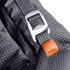 A cooler bag in grey with a silver buckle and an orange tag, featuring a geometric pattern and smooth fabric.