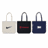 Three tote bags in various colours: a beige bag with a logo, a black bag with a logo, and a navy bag with a logo.
