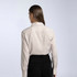 A women's button-up shirt in a cream and brown check pattern, featuring a collar and long sleeves.