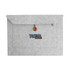 A grey felt laptop bag featuring a button closure and a front pocket with a logo.