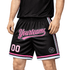 A pair of black basketball shorts with pink accents, featuring a logo and text design.