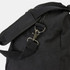 A black canvas duffle bag featuring a zipper and adjustable shoulder strap with a metal clasp.