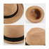 A tan string straw hat featuring a black band, shown from multiple angles, including the interior view.