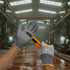 Cut resistant PU gloves are shown in grey with a yellow trim, being worn while handling a utility knife.