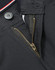 A close-up of a zipper and button detail on black chino pants, featuring sturdy fabric and an internal waistband design.