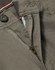 A close-up of grey chino pants showcasing a zippered fly and button closure, with a hint of contrasting interior detail.
