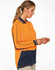 A woman wearing a hi-vis long-sleeve polo in orange and navy, featuring a logo and contrasting panels.