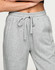 Grey unisex sweatpants with an elastic waistband and drawstring, featuring side pockets and a logo.