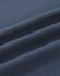 A close-up of soft, dark navy cotton fabric with smooth folds, showing its texture and quality.