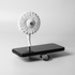 A white rechargeable fan with a flexible neck attached to a black phone stand. It features a logo on the fan.
