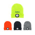 A collection of beanies in bright yellow, orange, black, and grey, each featuring a headlamp on the front.