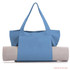 A blue canvas bag with two handles holds a rolled yoga mat, featuring a logo on the bag.