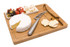 A bamboo cheese board featuring a round brie, crackers, olives, and a silver knife. It has a branding logo.