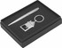 A silver pen, a metal keyring in the shape of a house, and a gift box with a black interior.