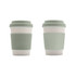 A drink bottle styled coffee cup in pale green, made from bamboo fibre with a silicone lid and sleeve, featuring a logo.