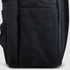 A black travel backpack featuring a textured exterior and side pocket. It has a logo on the front.