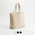 A cream tote bag featuring three pockets and two sturdy handles, with options in black and navy.