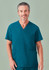 A unisex pulse v-neck scrub top in teal, featuring a pocket and a logo. The model is smiling.