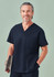 A unisex navy V-neck scrub top with a pocket, worn by a smiling model holding a clip folder.