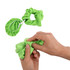 A green scrunchie-style drink cover and a hand holding the scrunchie, demonstrating its elastic feature.
