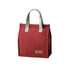 A red minimalist lunch bag with grey handles and a branded patch on the front.